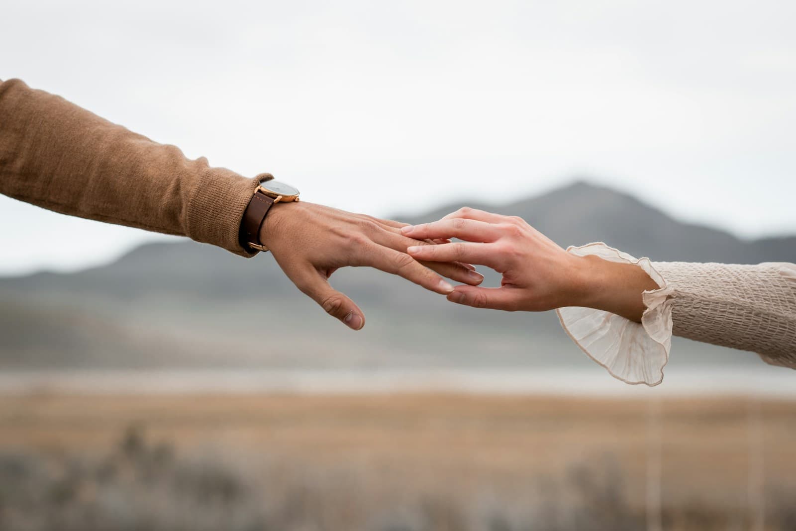 Two people reaching to hold hands — the support of someone beside you.