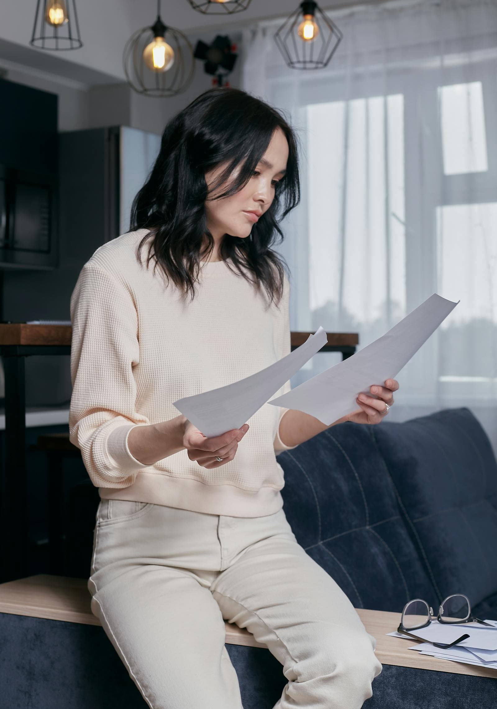 A woman working calmly through estate paperwork at home.