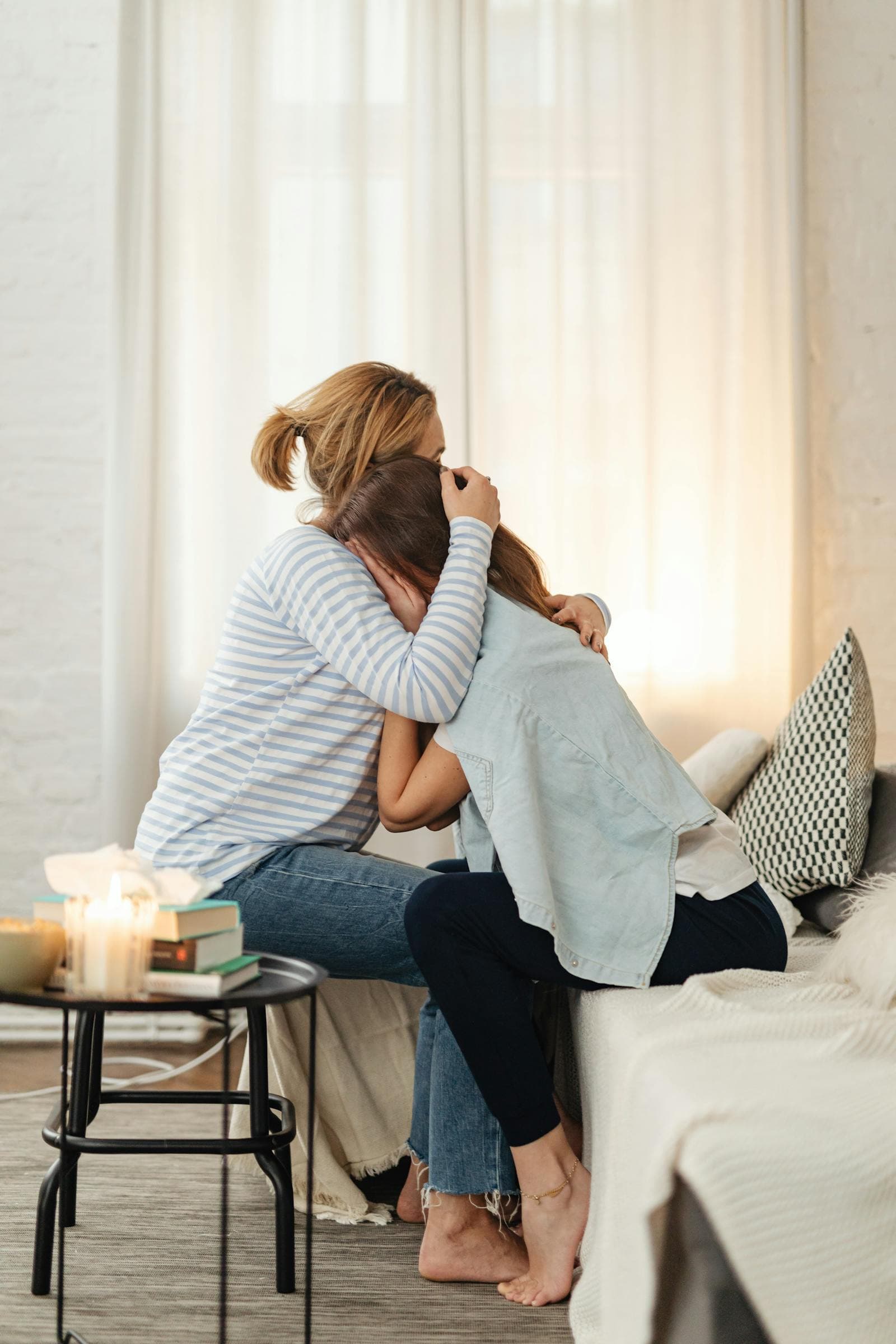 One person comforting another at home after a loss.