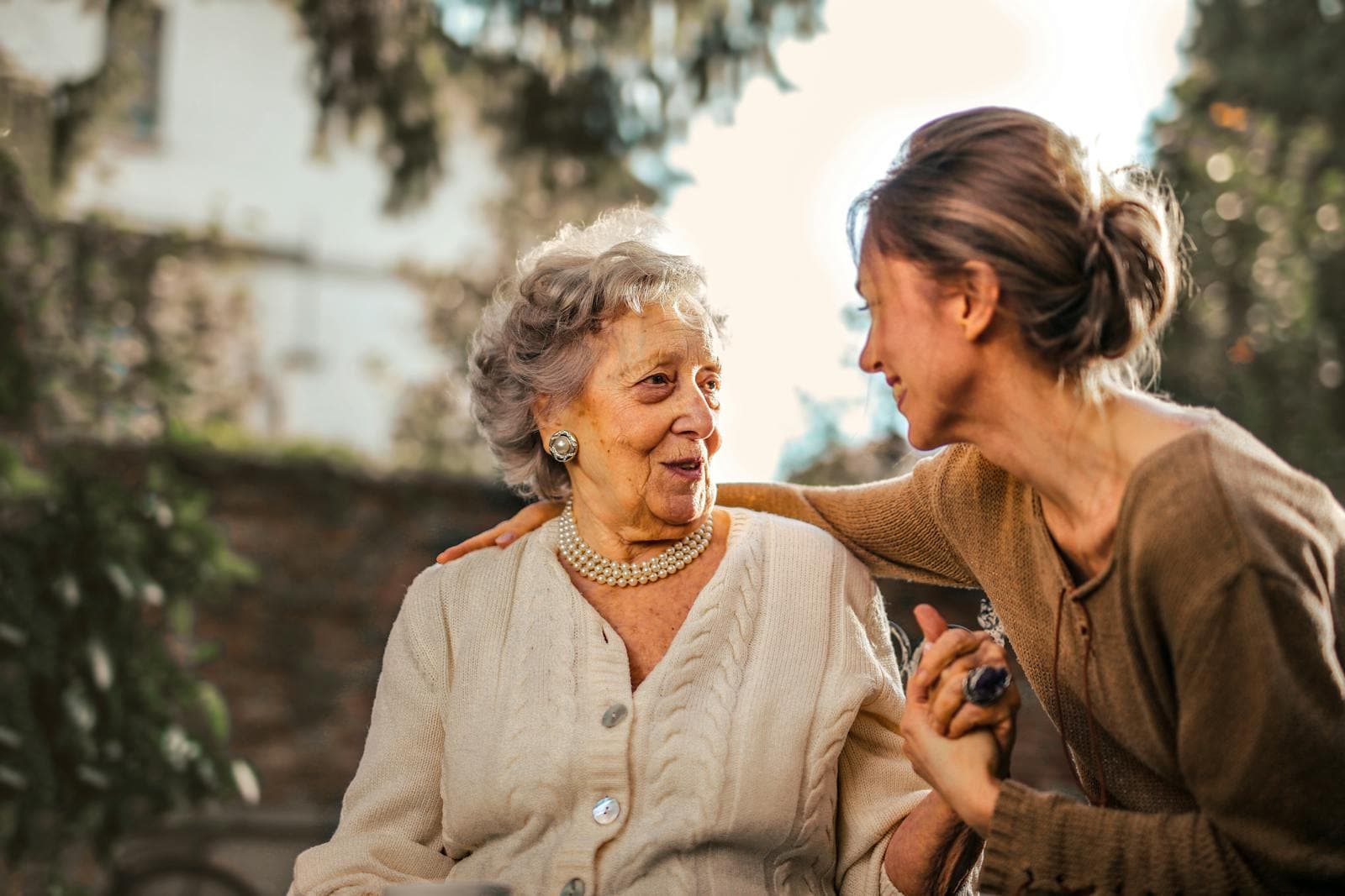 An older woman and her daughter together, hand in hand.